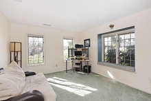 With grassy views all the way around, the den is a cozy space with new carpeting and a charming window seat. 