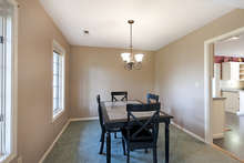 Large windows in the dining room overlook the landscaped front yard. The walls are freshly painted. 