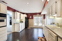 Spacious and flooded with natural light, the eat-in-kitchen features a new refrigerator and range, double oven, double sink, ample laminate countertops, recessed overhead lighting, and a built-in-microwave. 
