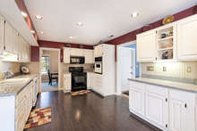 Wainscoting and painted cabinetry add a farmhouse-inspired touch. 