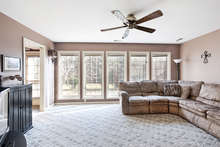 This living room is the perfect family gathering place. With fabulous light from a wall of oversized windows, it’s a warm, welcoming, and spacious room. It also features a ceiling fan and is freshly painted. 