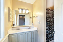 The attached master bath has double sinks and a tub shower. 