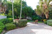 The large backyard has a northwest exposure with one of three courses at The Club Pelican Bay seen in the distance.