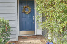 The walkway leads to this sweetheart of a front entrance. A trellis on the right-hand wall adds a natural touch.