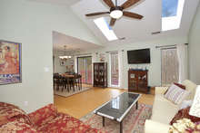 From two skylights, to floor-to-ceiling windows, to sliding glass doors, the open-floor plan is filled with beautiful natural light. Cathedral ceilings add a dramatic tone. 