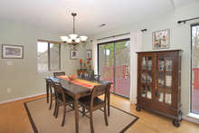 A beautiful lighting fixture hangs over the dining area. Sliding glass doors lead directly out to the deck, which has been freshly stained. 