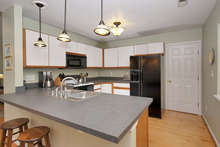 With Formica countertops, tons of cabinets, a double sink, dishwasher, built-in microwave, and GE profile refrigerator, this kitchen will satisfy any cook. 