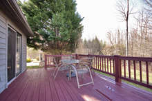 Enjoy the home’s beautiful natural setting from the newly stained deck, which is perfect for family meals outdoors and spacious enough for entertaining. Surrounding trees keep it private, but it still gets lots of sunshine. 